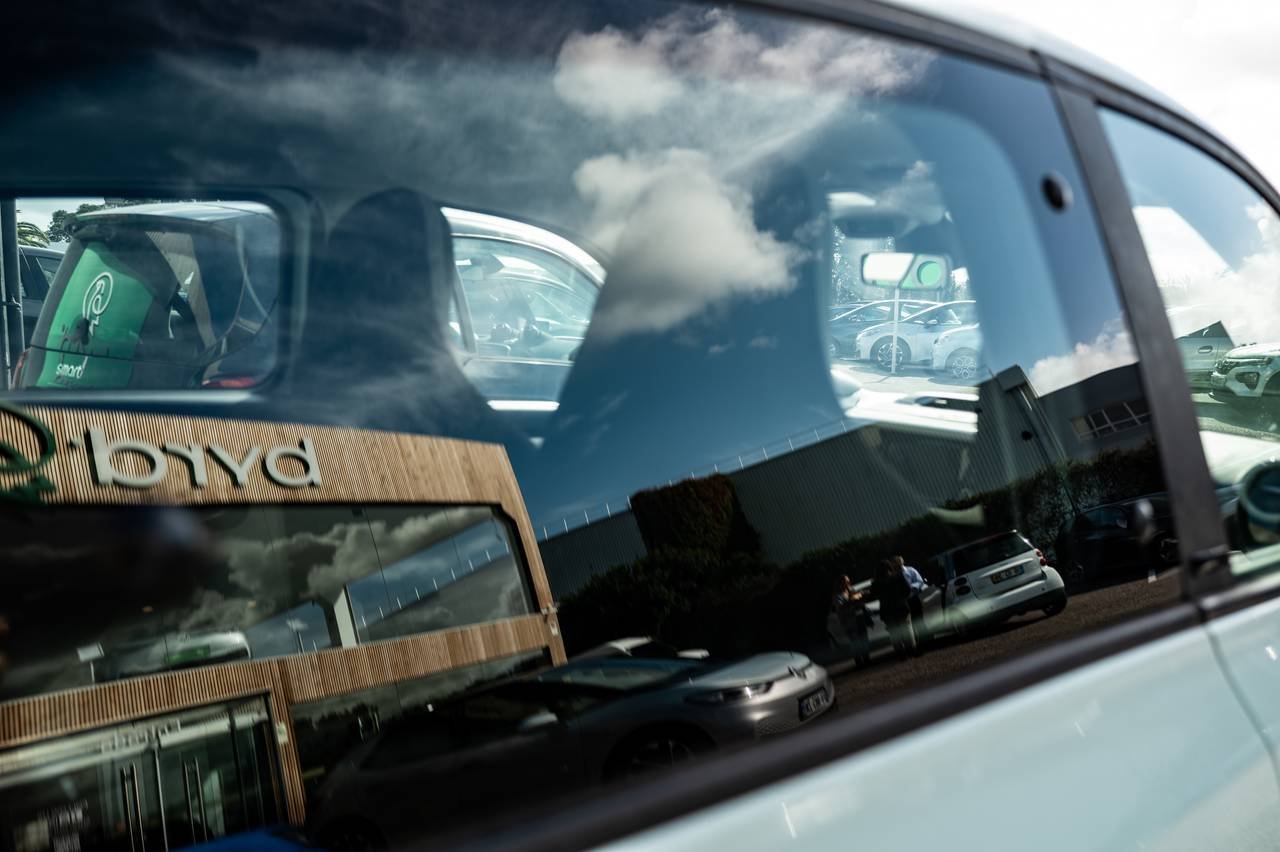 Reflections across an electric car’s window.