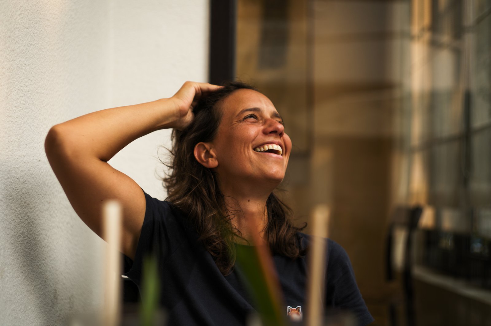 Portrait of Anne Catherine Nobre, laughing, in late afternoon light.
